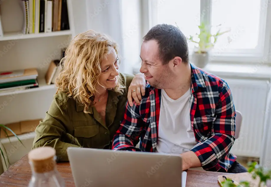 support worker with person using a laptop