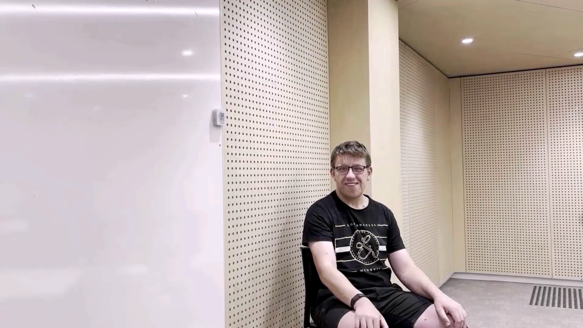 man sitting talking to talking to the camera