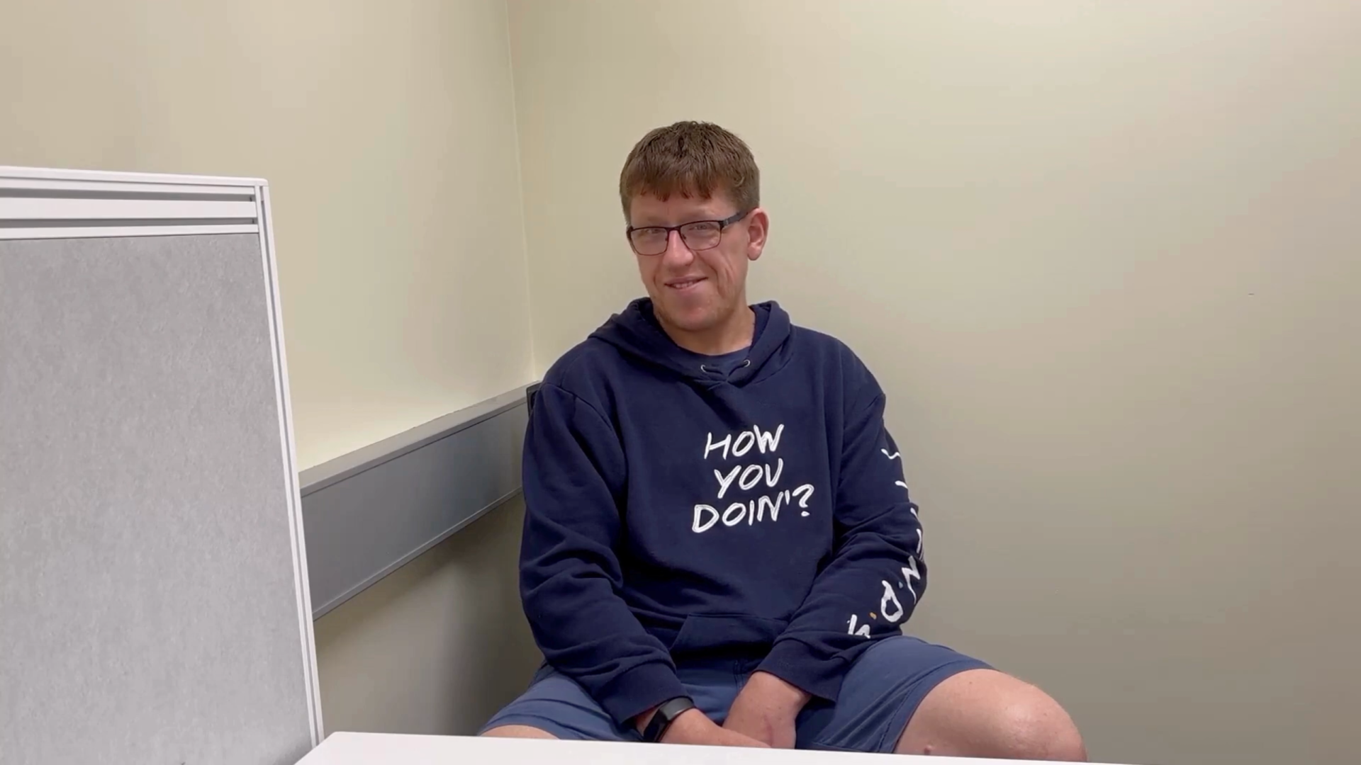 man sitting talking to camera