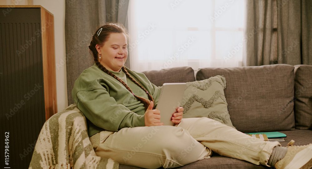Young woman relaxing and using her tablet computer